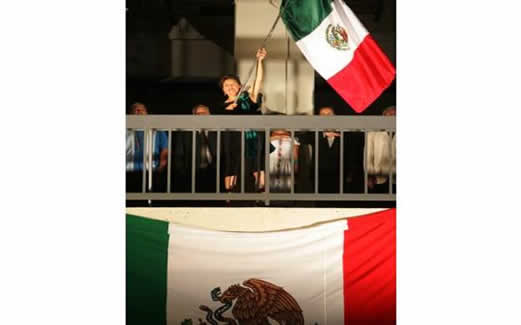 Carolina Zaragoza Flores, Mexican Consul in San Bernardino, waves the Mexican flag, on Monday, Sept. 15, 2014, at Cal State San Bernardino during a Mexican Independence Day celebration. The evening-long festivities featured Zaragoza Flores reciting the traditional words and the names of Mexican independence heroes, ending with the threefold shout of Viva Mexico!  